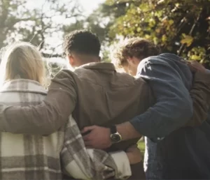 Family supporting each other with hands across shoulders